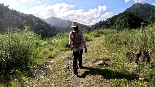 Perlita Marques walking upstream along the Diabobo River in Diteki, Aurora Province, Philippines, during a mobile recording session (2024).